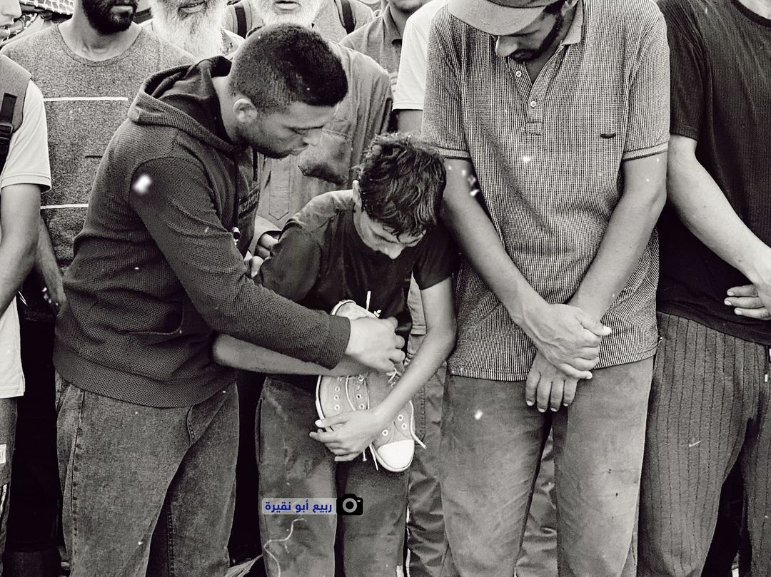 Boy Clings to Shoes of His Dad Killed by Israeli Bombs